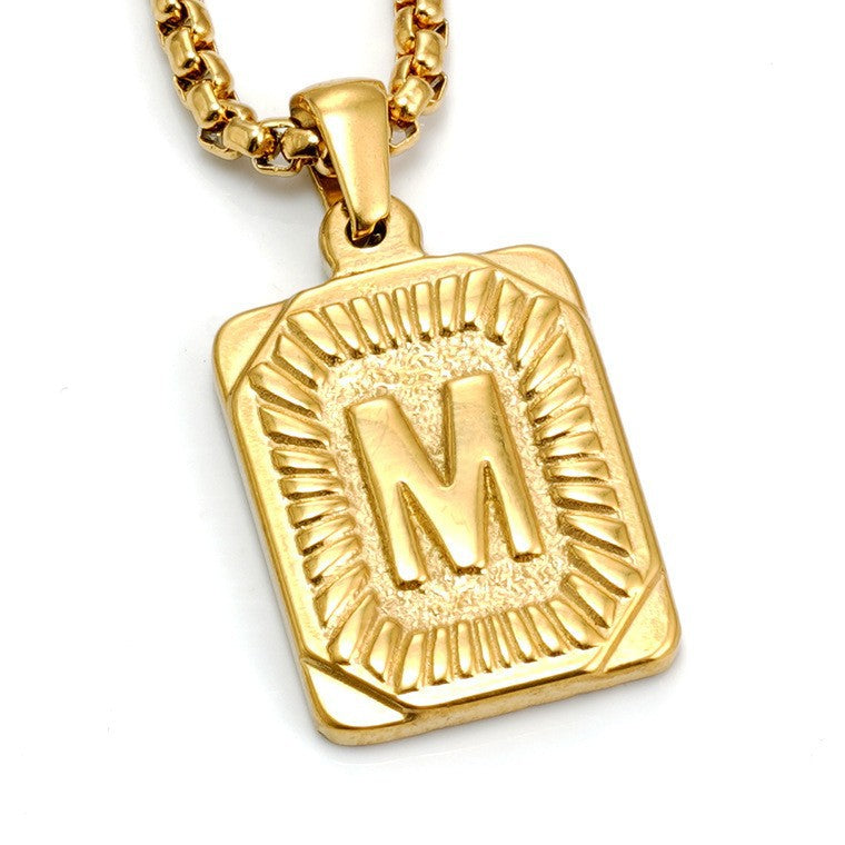 The Initial gold stainless steel letter M pendant, studio shot
