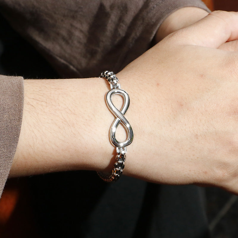 The Infinity silver stainless steel bracelet worn on wrist, close-up