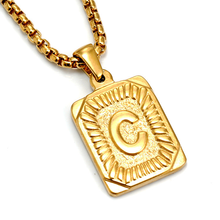 The Initial gold stainless steel letter C pendant, angled studio shot